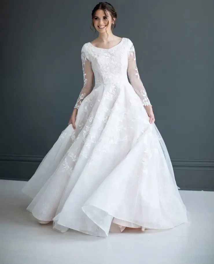 Model wearing a white gown by BE Collection