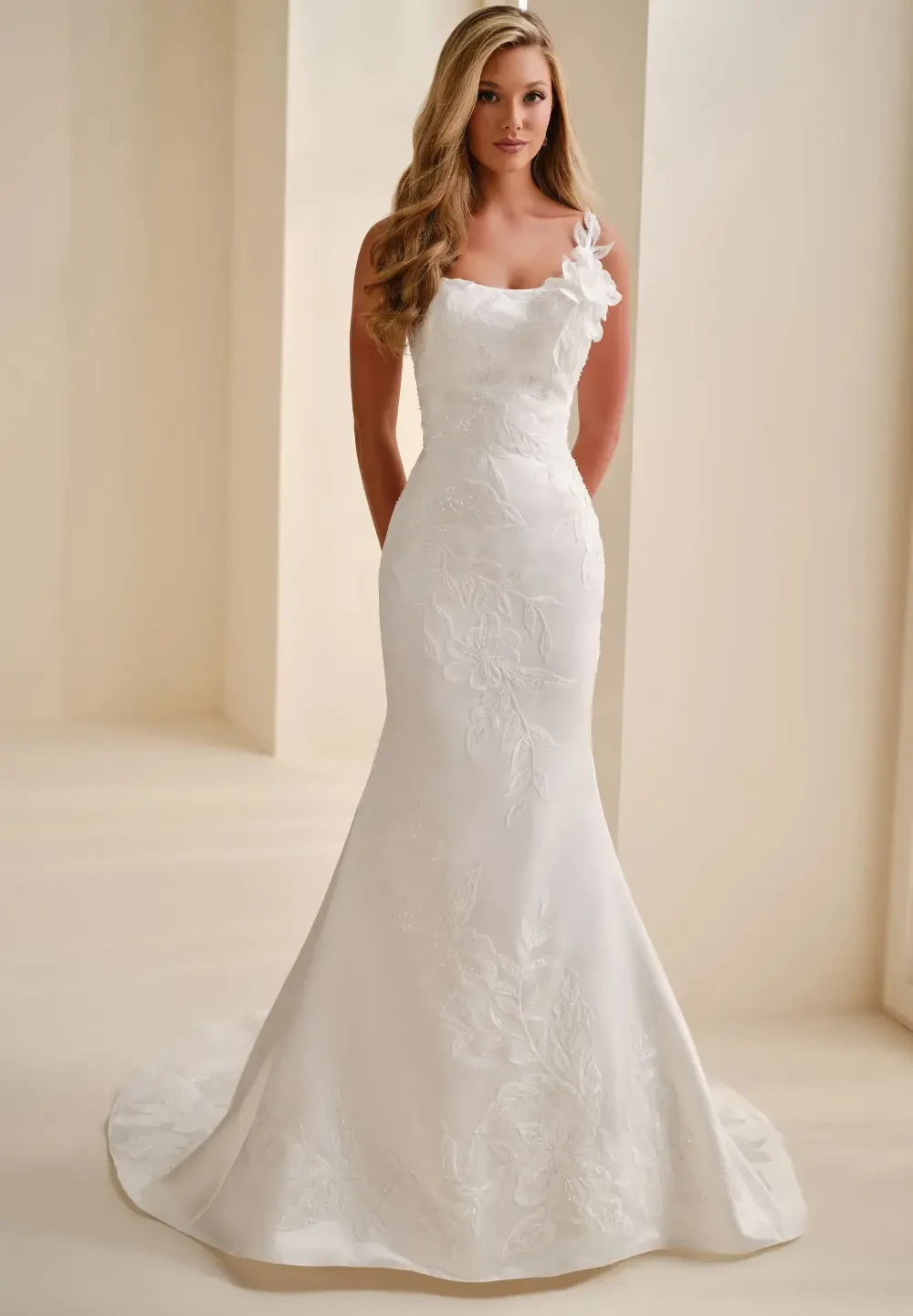 Model wearing a white gown by Mon Cheri